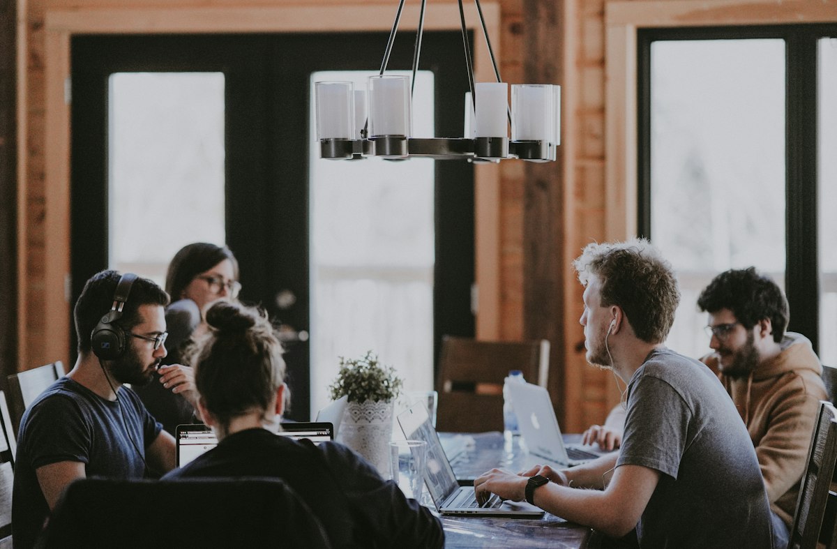Business executives in a conference meeting discussing digital agency proposals, contract deliverables, and performance metrics