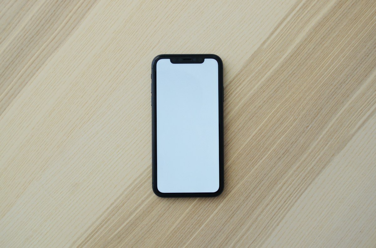 User holding a smartphone to authenticate streaming service credentials and pair device with an activation code
