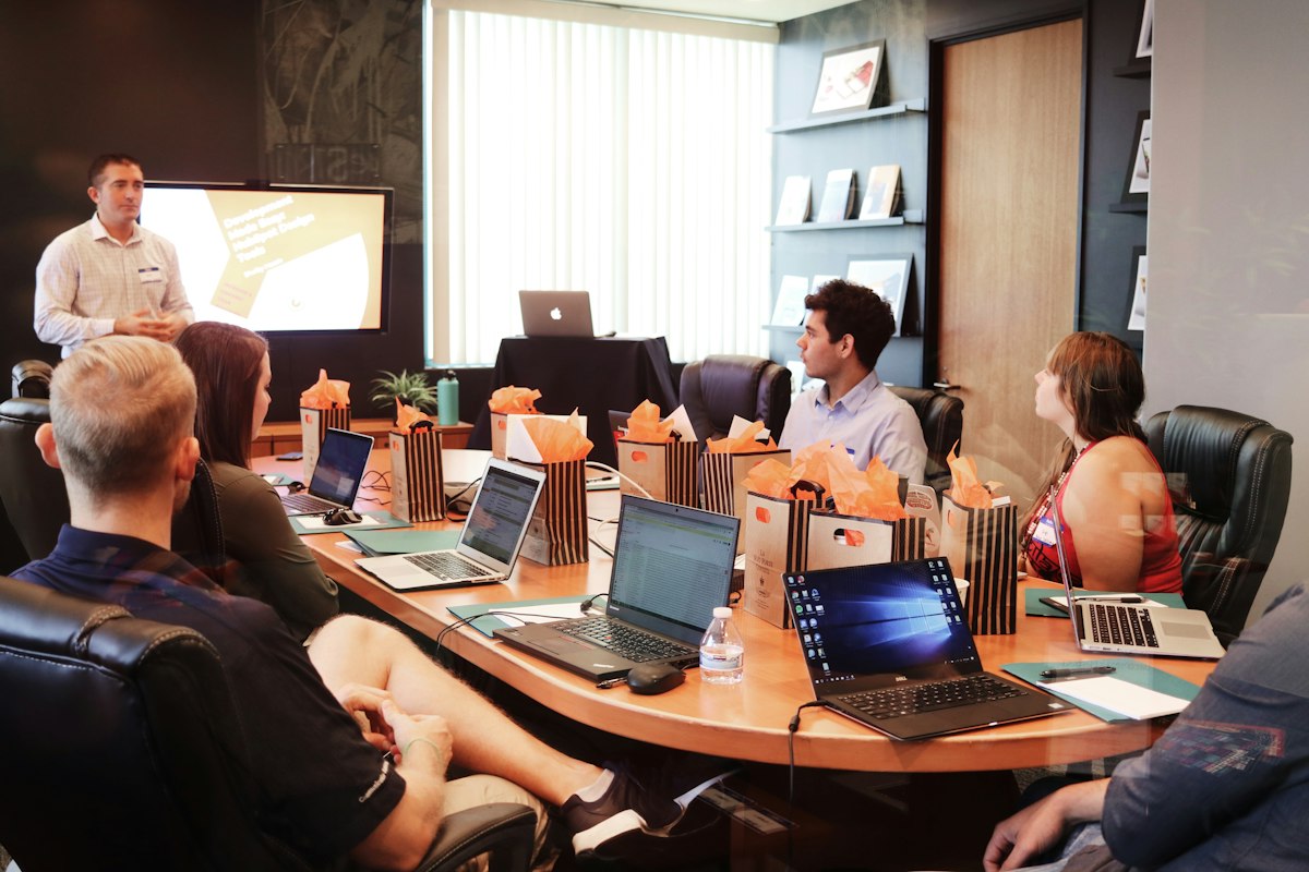 Growthscribe digital marketing agency strategy session showing growth marketers analyzing multi-channel performance data on laptops and digital displays