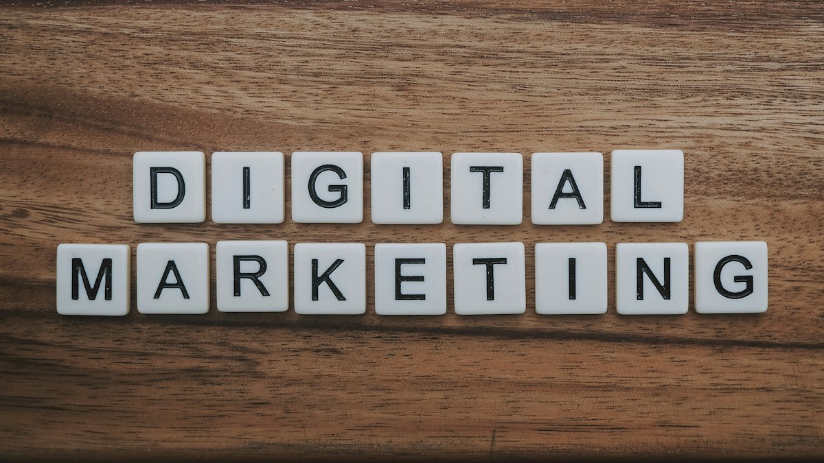 Digital marketing professional working on laptop evaluating account safety, platform compliance, and multi-channel campaign strategies
