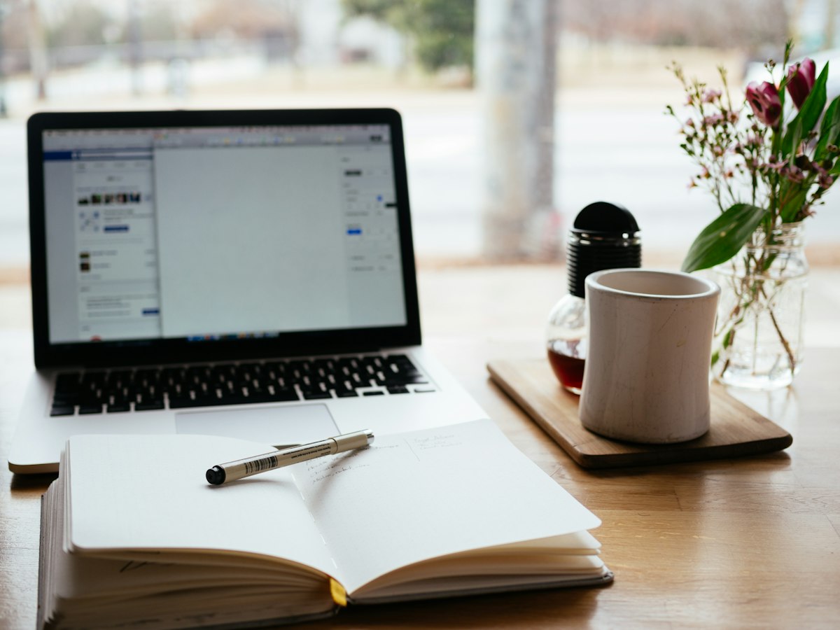 Reader browsing digital articles and online publications on a tablet in a bright modern workspace