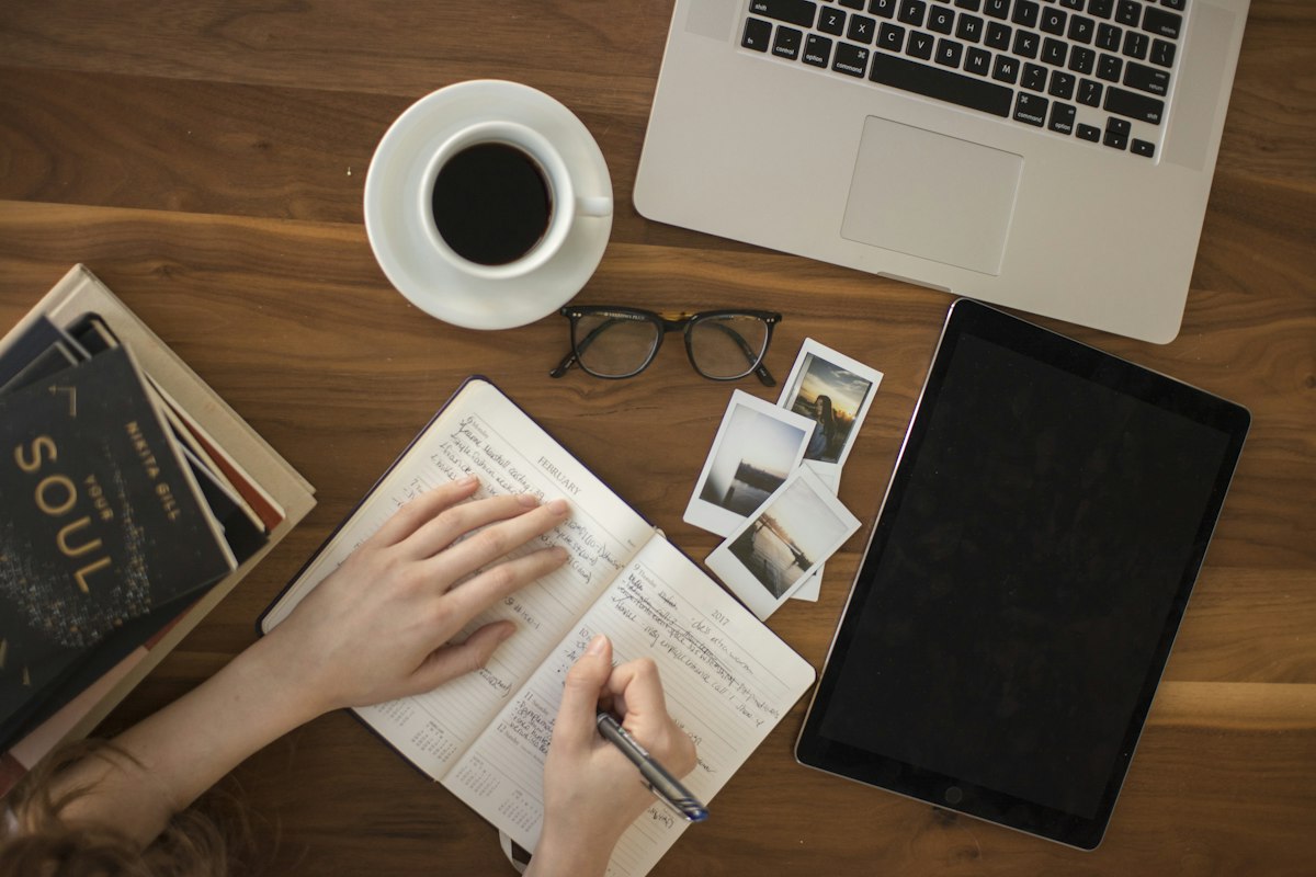 Modern workspace featuring laptop and journal for reading diverse topics across technology, business, and lifestyle