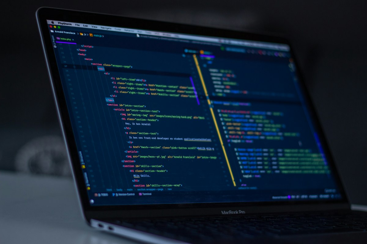 Software developers reviewing code architecture, programming algorithms, and technical documentation on computer monitors