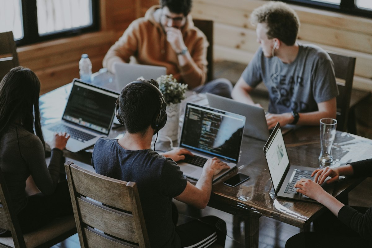 Technology team collaborating on digital marketing strategy, comparing editorial publishing platforms with full-service agency architectures