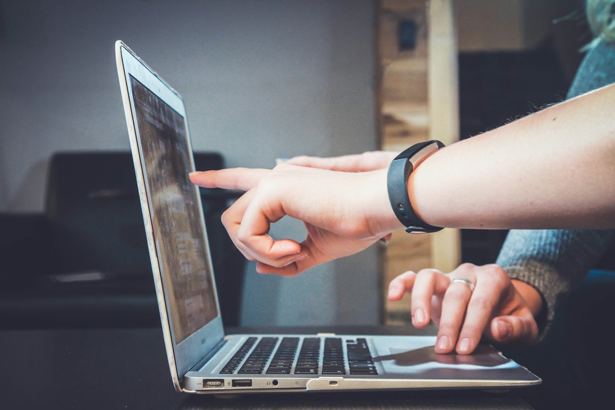 Student and professional researcher browsing digital educational articles, fact-checking sources, and taking notes
